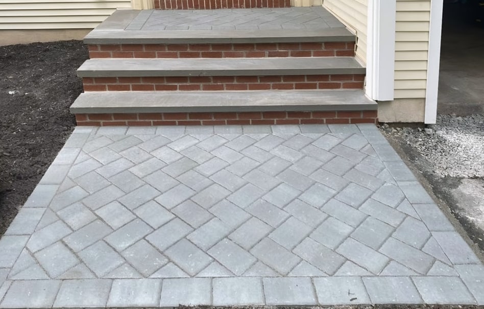 Paver entry walkway and brick steps with gray stone treads