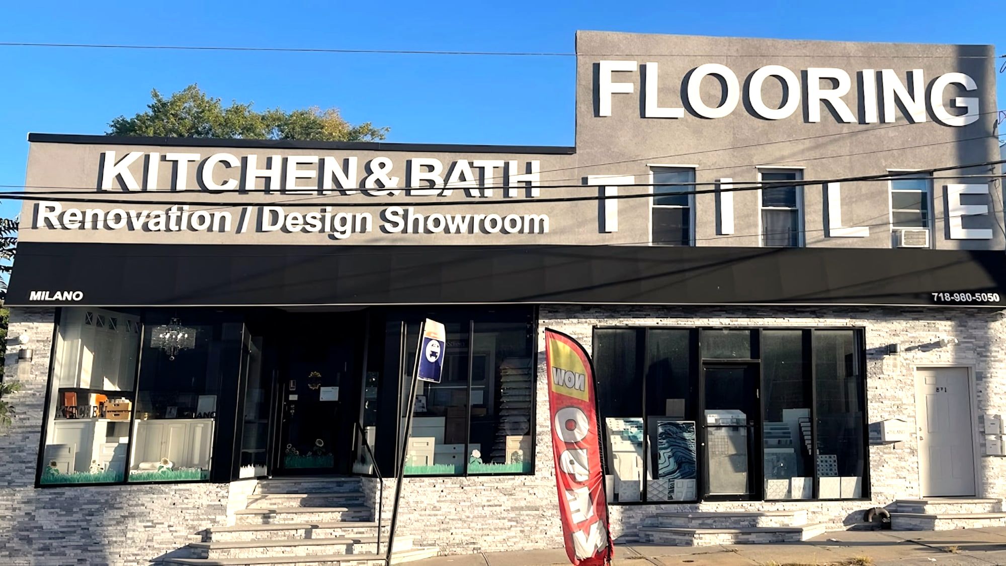 Two-story storefront with Kitchen & Bath showroom, Flooring and Tile signs